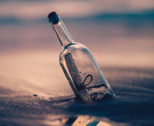 Glass bottle washed up on the shore containing a message